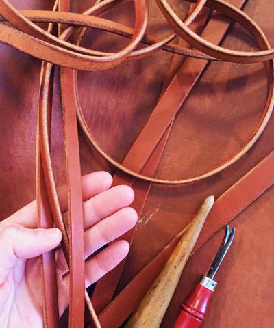 natural vegetable tanned leather pairs perfectly with recycled sails for an earthly look.